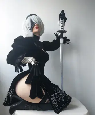 Woman in a black outfit holding a sword