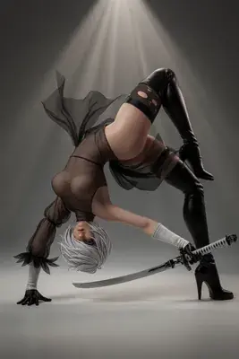 A cosplayer portrays 2B (YoRHa No.2 Type B) from NieR: Automata in a dramatic, inverted pose with a sword and black high-heeled boots.