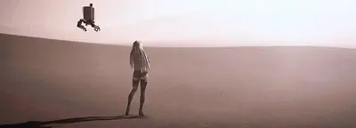 Fan art of 2B (YoRHa No.2 Type B) from NieR: Automata standing in a vast desert with a drone floating above.