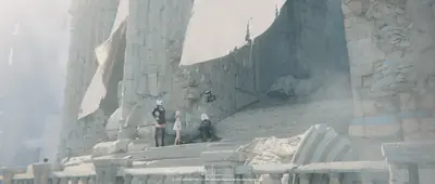 Fan art of 2B (YoRHa No.2 Type B) from NieR: Automata standing amidst crumbling stone ruins in a post-apocalyptic setting.