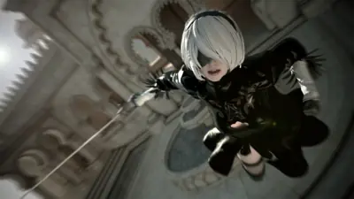 2B (YoRHa No.2 Type B) from NieR: Automata shown in a dynamic action pose with her sword drawn, set against a gothic architectural background.