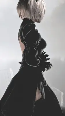 2B (YoRHa No.2 Type B) from NieR: Automata shown in a gothic-lolita style black dress with a blindfold, standing in a post-apocalyptic environment.