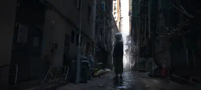 2B (YoRHa No.2 Type B) stands in a narrow, debris-filled alleyway in a post-apocalyptic setting from NieR: Automata.