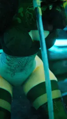 Low-angle view of 2B from NieR:Automata, showcasing her outfit and neck markings.
