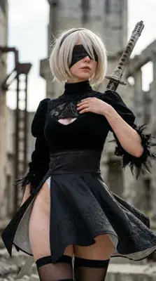 Cosplay of 2B from NieR:Automata standing in a ruined environment.