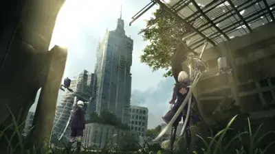 Two androids, 2B and 9S, stand in a ruined city with swords drawn, overlooking dilapidated skyscrapers under a bright sky. Flying machines are visible in the background.