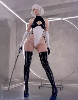 Woman in a white bodysuit and black boots