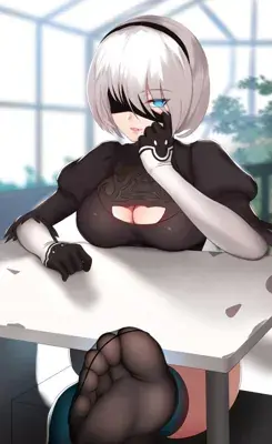 Woman sitting at a table with her hand on her face
